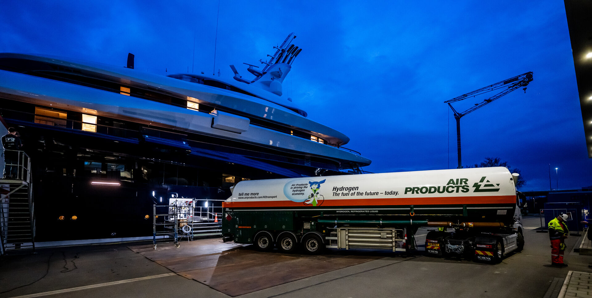 Truck-to-ship hydrogen bunkering operation showing tube trailer delivering hydrogen to vessel at quayside